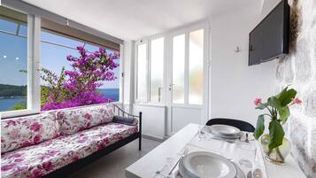Standard Apartment, 1 Bedroom, Terrace, Sea View | Living area | 20-inch flat-screen TV with cable channels, TV