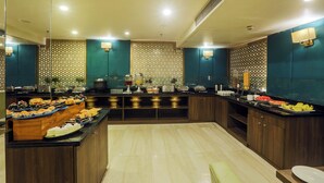 A buffet setup with various food items and a counter.