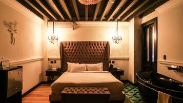 Relax in comfort with a large tufted headboard bed and modern bathtub.