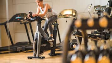 A gym with stationary bikes, treadmills, and exercise equipment.