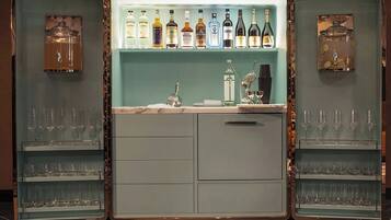 A bar area with shelves of liquor bottles and glasses.