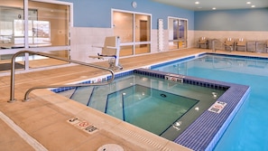 A swimming pool with a lifeguard chair, a diving board, and a clock on the wall. - Holiday Inn Express & Suites Parkersburg East by IHG (Parkersburg)