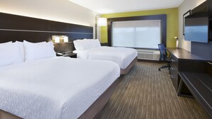 A hotel room with two beds, a desk, a chair, a TV, and a large window.
