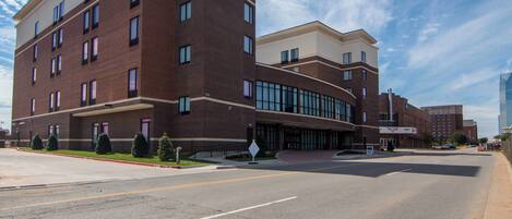 A multi-story hotel with a brick facade and large windows.