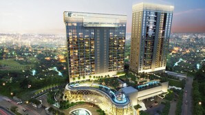 A high-rise hotel with multiple floors, a central atrium, and a landscaped area with a fountain.