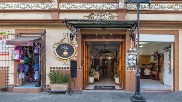 A building with ornate architectural details, a storefront with a sign reading "Collection Casa Garay," and a street lamp in front. - Hotel Boutique Casa Garay (Oaxaca)