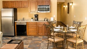 A compact kitchen with wooden cabinets, a stainless steel refrigerator, a microwave, and a coffee maker. - Villas At Poco Diablo (Sedona)