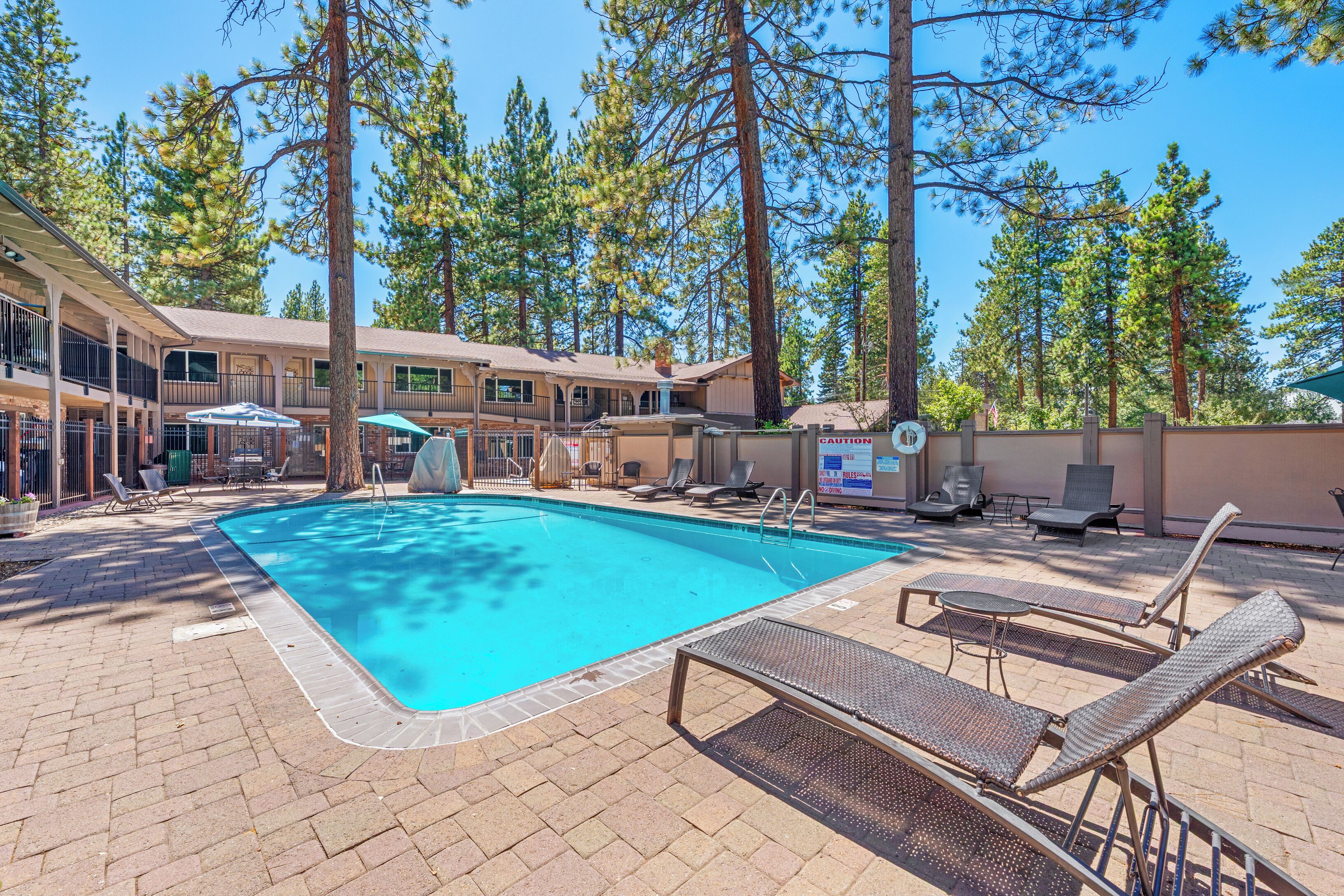 A pool area with lounge chairs and a pool.
