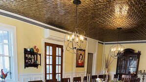 A dining room with a long wooden table set for a meal, surrounded by chairs. - Carriage House B&B (Winona)