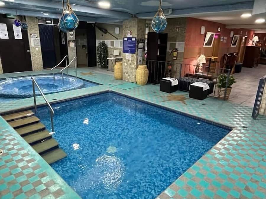 Indoor pool, open 10:00 AM to 10:00 PM, pool loungers