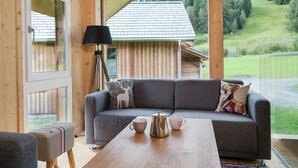 A cozy living room with a gray sofa, a coffee table, and a lamp.