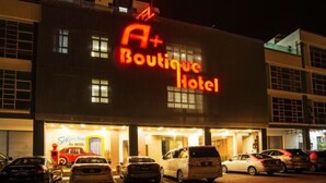 A building with a neon sign reading "A+ Boutique Hotel". - A Plus Boutique Hotel (Sekinchan)
