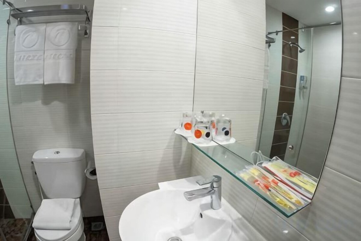 Bathroom | Shower, free toiletries, slippers, towels