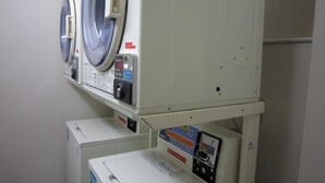 A laundry room with two stacked washing machines and a dryer. - JR East Hotel Mets Yokohama Tsurumi (Yokohama)