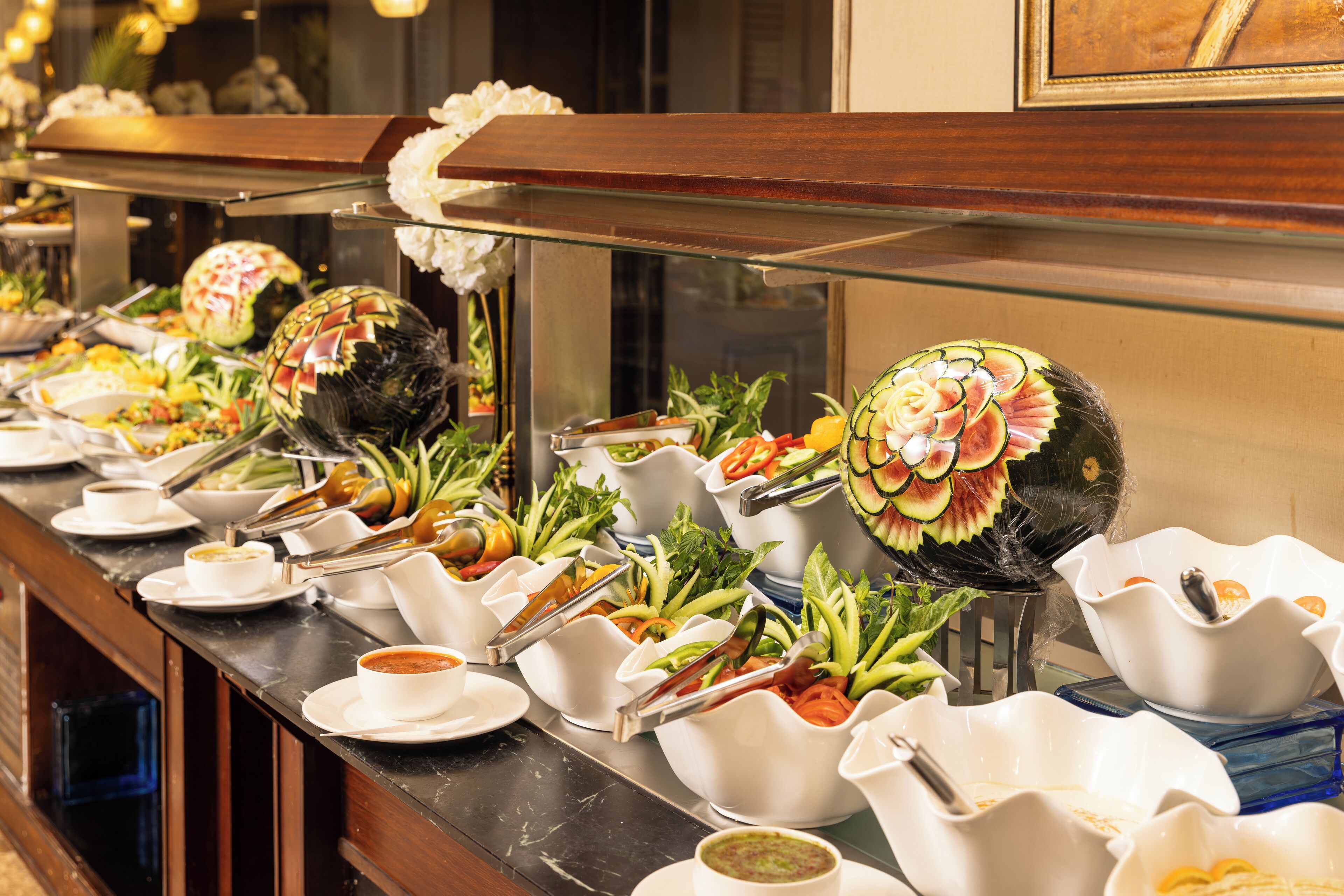 A buffet with various dishes and utensils.