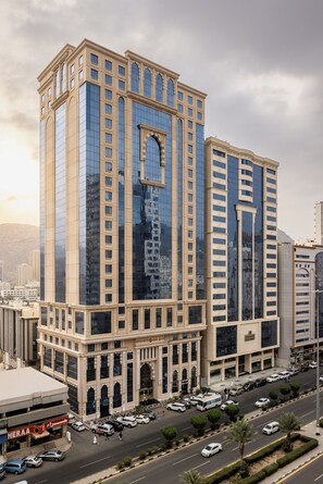 A high-rise building with a modern glass facade and classical architectural elements.