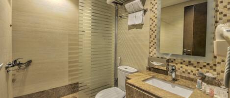 A modern bathroom with a glass shower enclosure, a toilet, a sink with a mirror, and a towel rack.