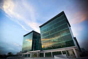 A modern building with reflective glass facade and a flat roof.