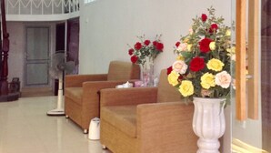 A spacious living area with a high ceiling, a large window, and a modern design.