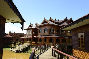 A traditional wooden building with a sign reading "Heritage Lodge." - Ann Heritage Lodge (Nyaungshwe)