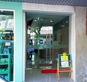 A hotel entrance with a glass door, a sign indicating 'OPEN', and a 'WELCOME' mat. - Jsia Hotel (Kota Kinabalu)
