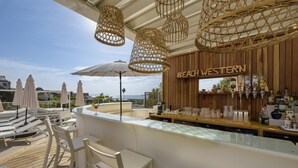 A beach-themed bar area with white bar stools, wicker hanging lights, and a view of the sea. - Résidence de Tourisme Ajaccio Amirauté (Ajaccio)