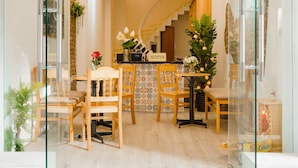 A booking tour travel service office with a reception desk, chairs, and a staircase.