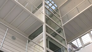 A multi-story building with a modern architectural design, featuring glass railings and a series of balconies. - SmartHotel Flamingo self-check-in (Giessen)
