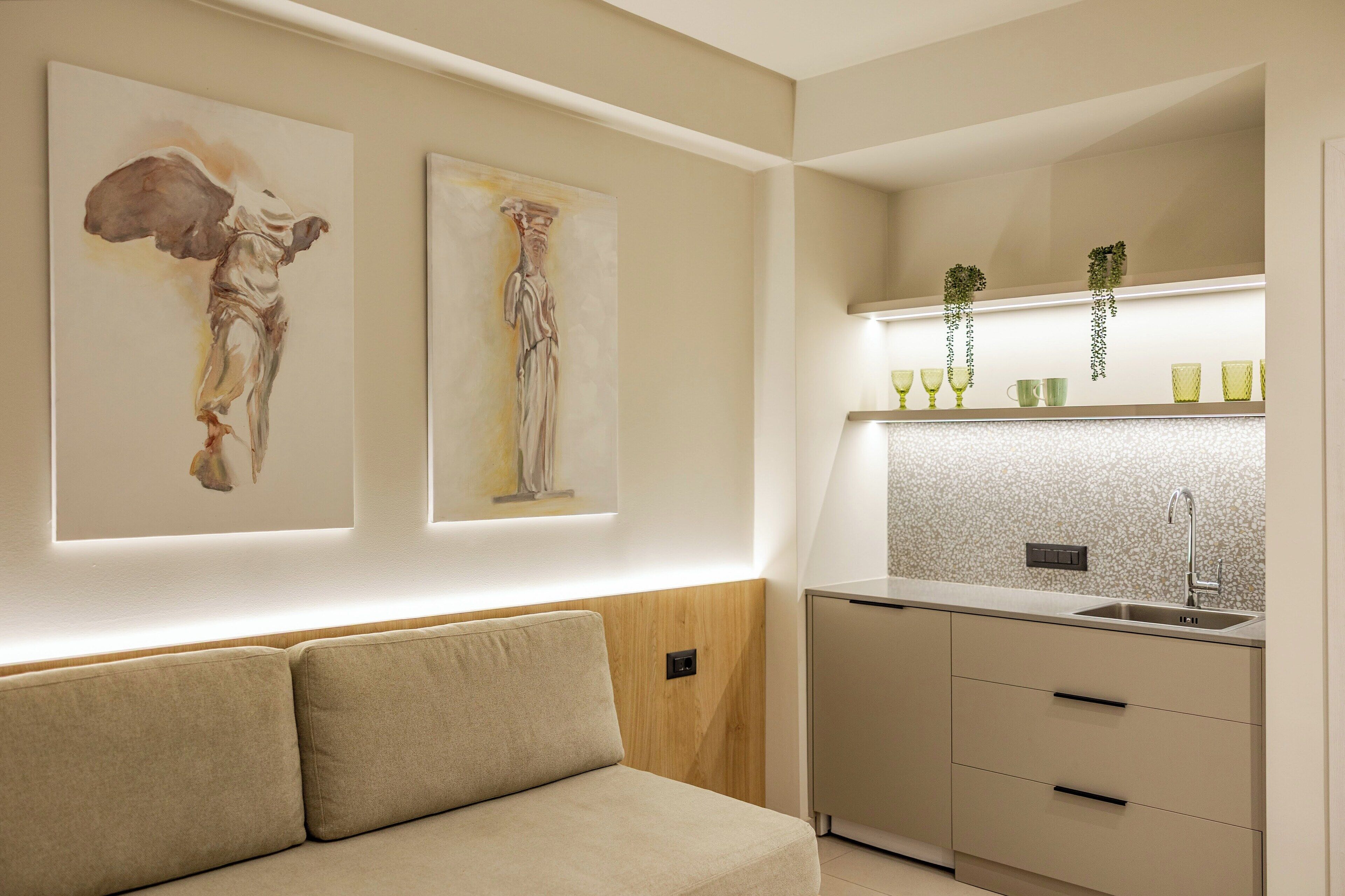A modern kitchen with a built-in sink, a countertop, and a wall-mounted shelf with decorative items.