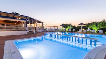Relax by the pool surrounded by a low deck and lounge chairs, offering a serene escape.