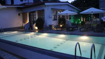 Alberca al aire libre y camastros