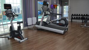 A gym with treadmills, an elliptical, and a rack of dumbbells. - Holiday Inn Express Red Deer North by IHG (Red Deer)