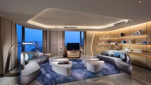A modern living room with a sofa set, a coffee table, and a TV. - Hilton Quanzhou Riverside (Quanzhou)