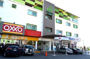 A hotel with a sign for 'Chateau Hotel Express' and 'Bianco' pharmacy.