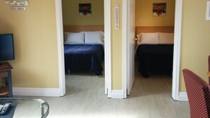 A hotel room with two beds, a ceiling fan, a thermostat, and artwork on the walls. - The Pinewood - Adult Getaway by the Lake (Lambton Shores)