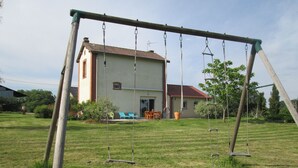 A house with a swing set in the yard. - Holiday Home in Crux-la-Ville near Lake (Crux-La-Ville)