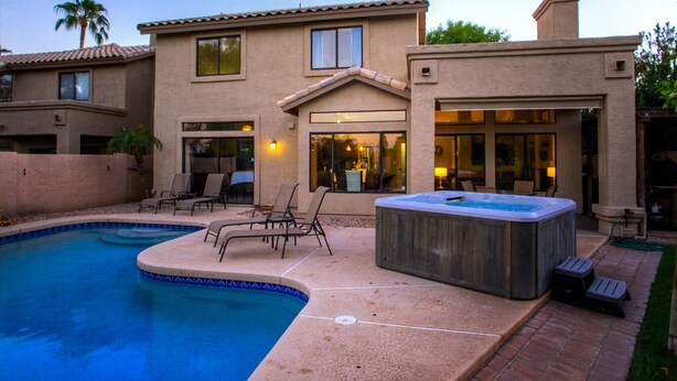 A residential property with a swimming pool, outdoor seating, and a hot tub. - Chandler - 4 Bedroom Home - Chandler (Chandler)