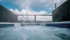 A hot tub area with a view of the sky and clouds. - Eleven Revelstoke Lodge (Revelstoke)