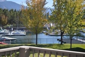 A marina with boats docked, a body of water, and trees in the foreground. - 489 Ala Wai, 48 3 Bedroom Condo by RedAwning (South Lake Tahoe)