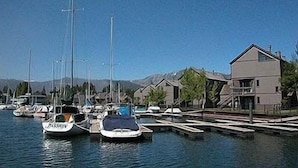 A marina with several boats docked, surrounded by residential buildings.