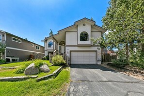 A two-story residential building with a garage, a front porch, and a well-maintained lawn. - 596 Danube Drive 3 Bedroom Home by RedAwning (South Lake Tahoe)