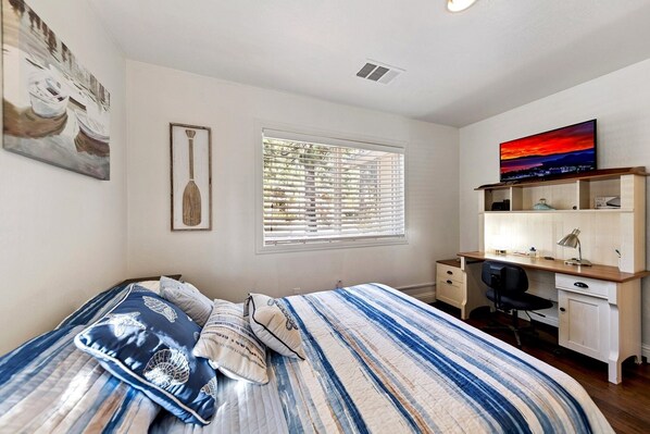 A bedroom with a bed, a desk, and a TV. - 917 Tahoe Keys Blvd by RedAwning (South Lake Tahoe)