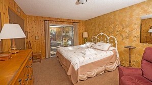 A bedroom with a bed, a dresser, a chair, and a lamp. - 948 Merced Avenue 3 Bedroom Home by RedAwning (South Lake Tahoe)