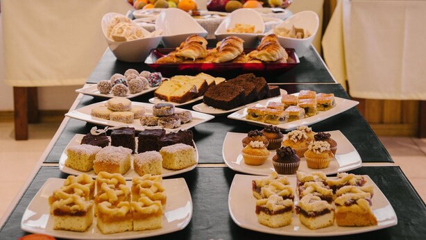 A buffet table with various desserts and pastries. - Hotel Tierra del Fuego (Ushuaia)