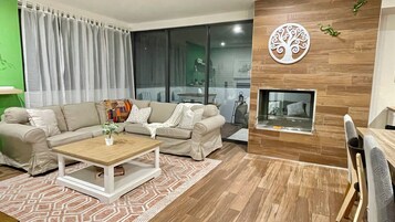 3 Bedroom Apartment | Living area | 32-inch flat-screen TV with satellite channels, TV, pay movies