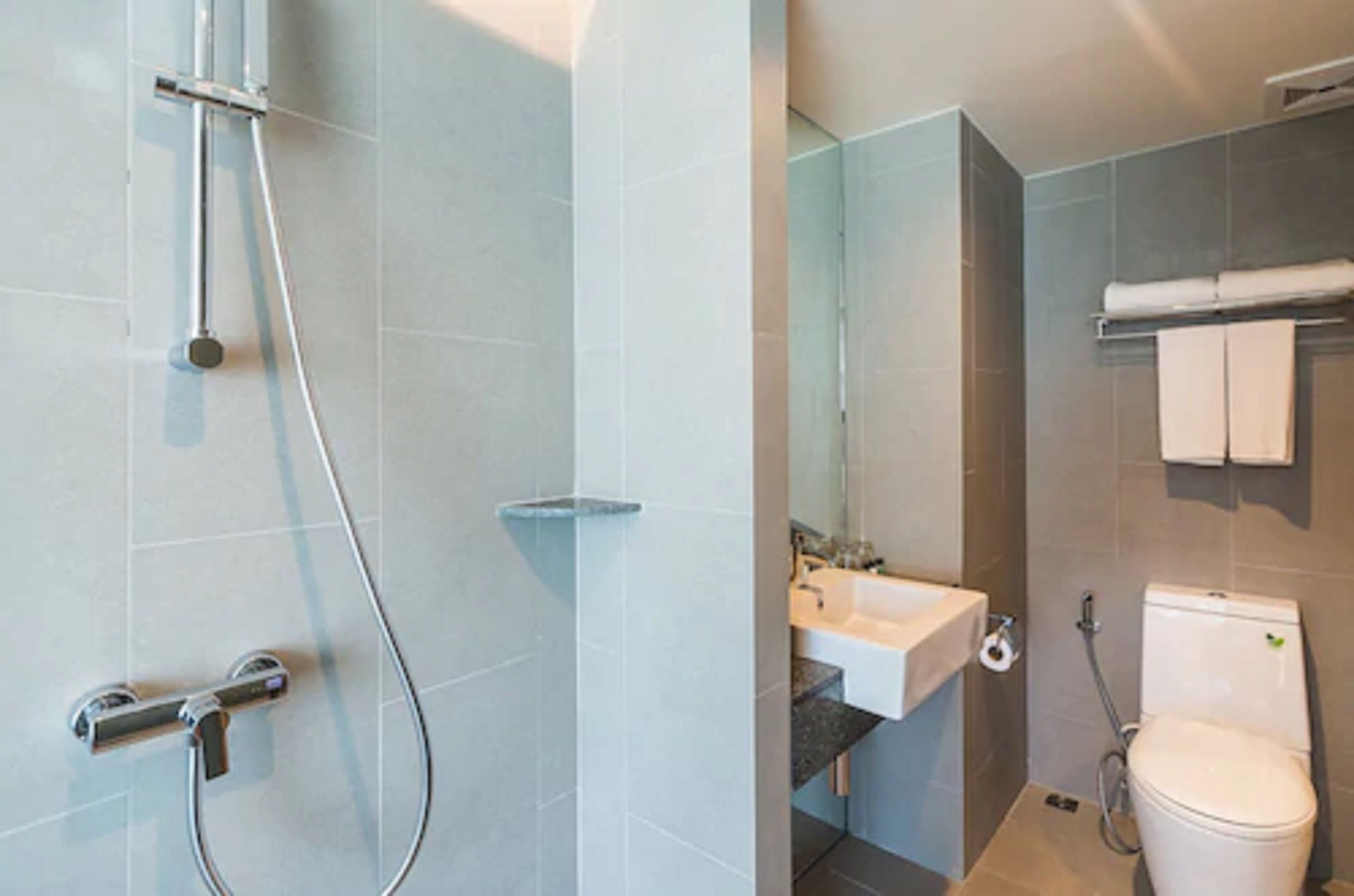 Un baño moderno con ducha, lavabo e inodoro.