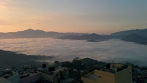 A mountainous landscape with a village at the base. - Hotel Crown (Tansen)