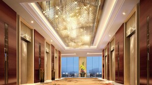 A spacious hallway with a high ceiling, modern chandeliers, and a large window offering a view of the cityscape. - Sorl Hotel Hangzhou (Hangzhou)