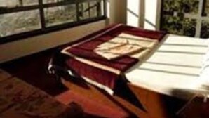 A room with a large window, a bed, and a book on the bed. - Hotel New Dragon (Baluwapati Deupur)