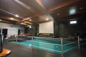 Una piscina techada, sillones reclinables de piscina